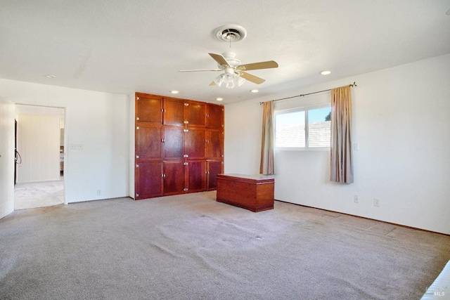 unfurnished bedroom featuring a ceiling fan, a closet, visible vents, and light colored carpet