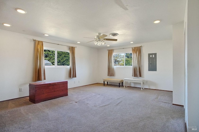 carpeted empty room with electric panel, visible vents, a ceiling fan, and recessed lighting