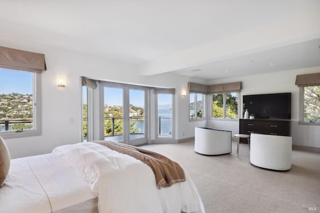 bedroom featuring access to outside, light colored carpet, and baseboards