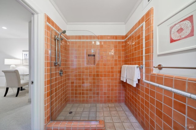 bathroom with ornamental molding and tiled shower