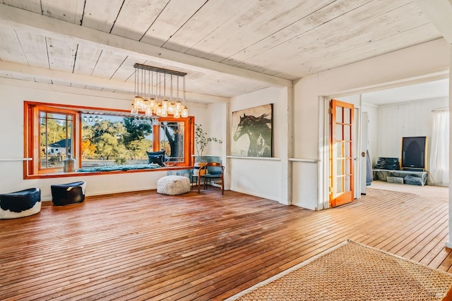 interior space featuring wood finished floors and an inviting chandelier