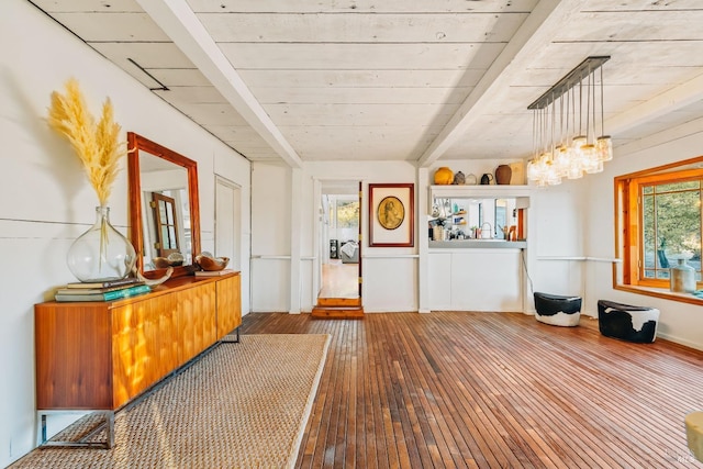 entrance foyer with beam ceiling and wood finished floors