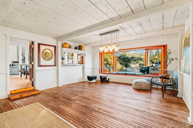 sitting room with wooden ceiling, wood finished floors, and a notable chandelier