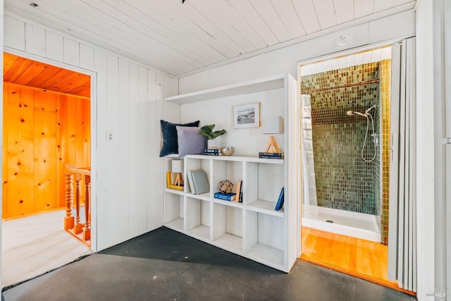 interior space featuring wood ceiling and wooden walls