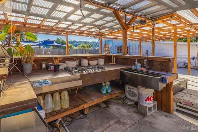 exterior space with outdoor dry bar, fence, and a ceiling fan