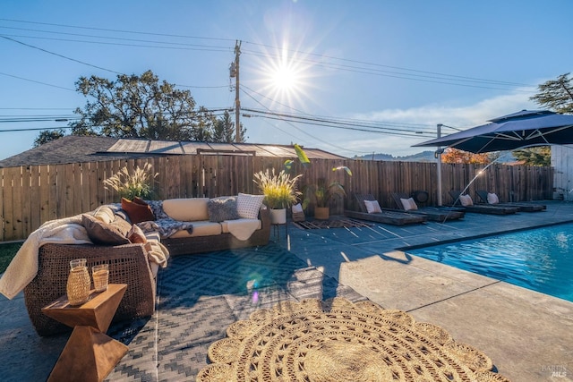 view of swimming pool featuring a patio area, a fenced backyard, an outdoor living space, and a fenced in pool