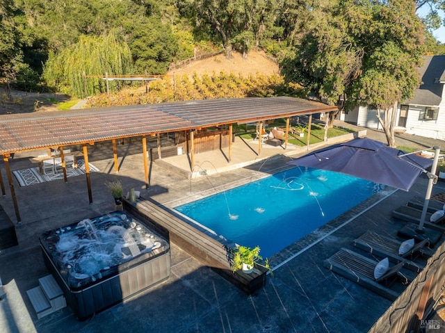 view of swimming pool with a patio area and a jacuzzi