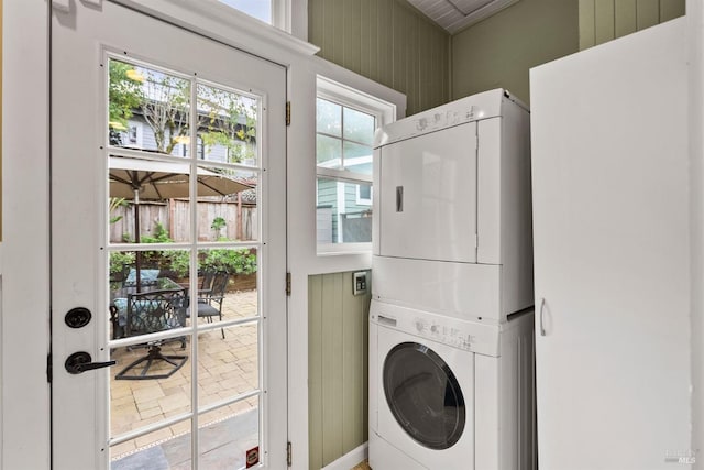 laundry area with stacked washing maching and dryer and laundry area