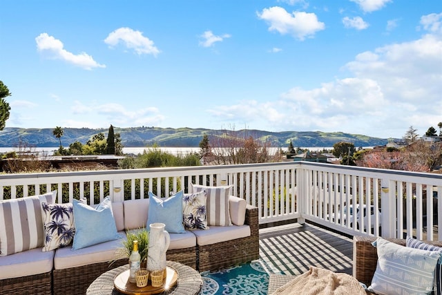 deck featuring a mountain view and an outdoor living space