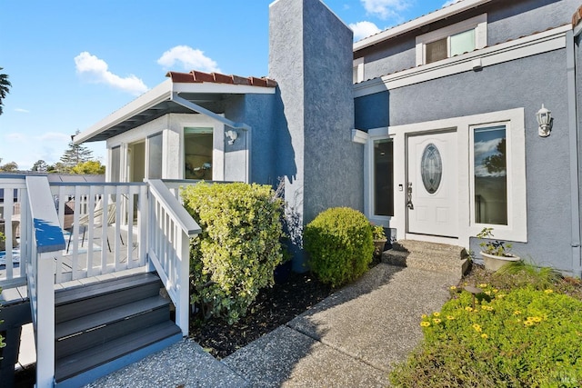 property entrance with stucco siding