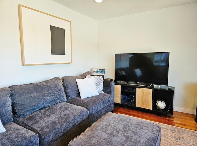 living room featuring dark wood finished floors and baseboards