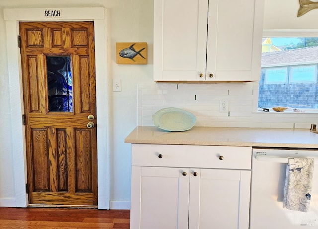 195 Ocean View Ave, Bodega Bay, CA 94923 - kitchen featuring dishwasher, tasteful backsplash, light countertops, white cabinets, and dark wood-style flooring