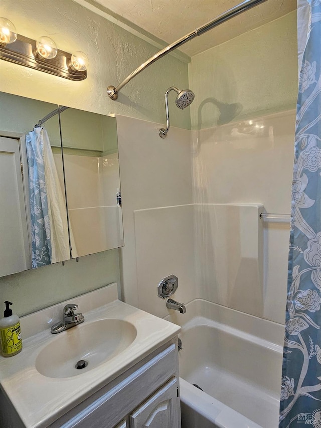 bathroom featuring vanity and shower / bathtub combination with curtain