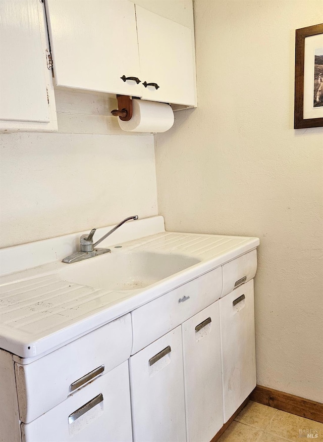 bathroom with vanity and baseboards