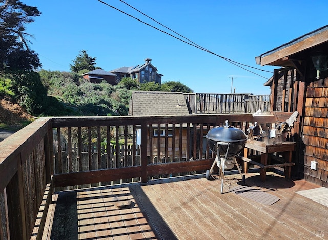 wooden terrace with a grill