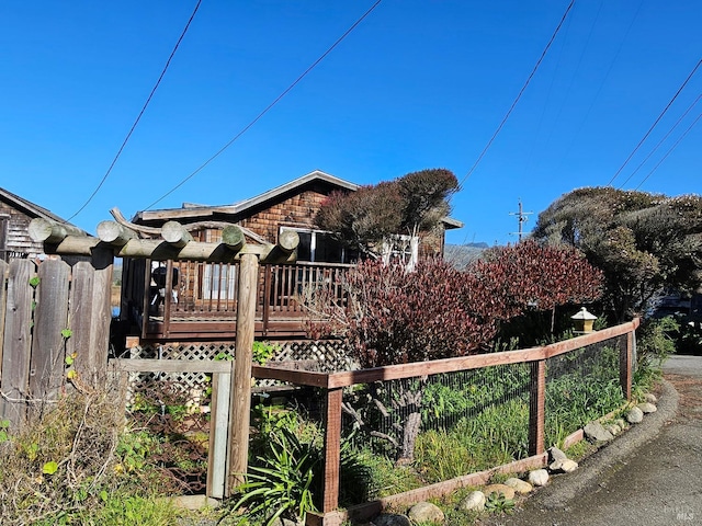 view of front of property with fence and a deck