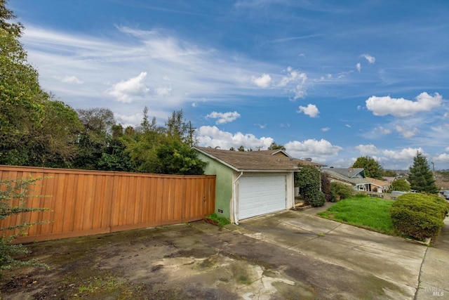 detached garage featuring fence