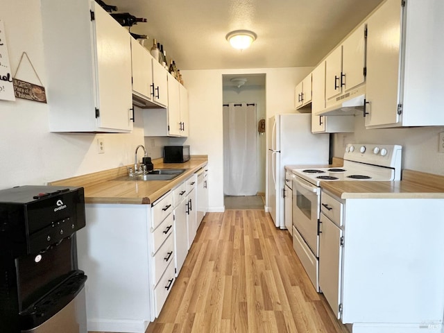 kitchen with under cabinet range hood, white appliances, a sink, white cabinets, and light countertops