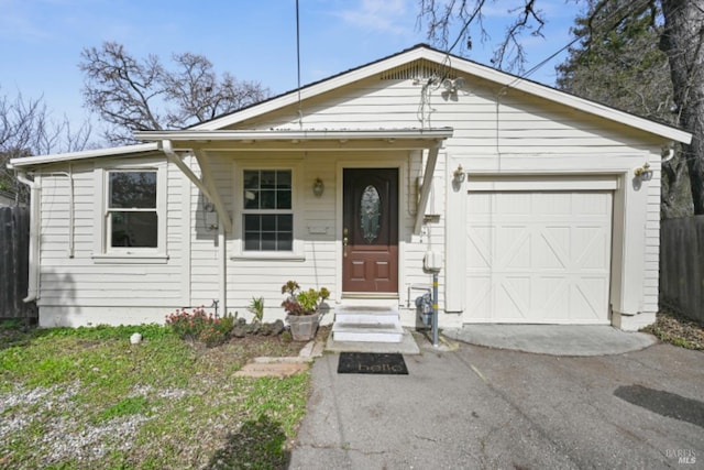 view of front of house with aphalt driveway, entry steps, and an attached garage