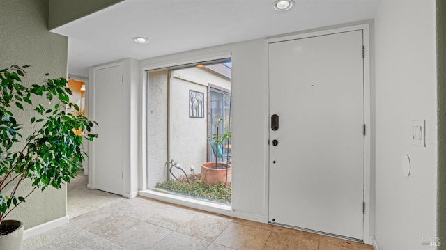 foyer with baseboards and recessed lighting