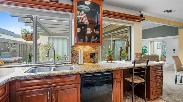 kitchen featuring dishwasher, a sink, visible vents, and a healthy amount of sunlight