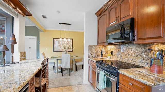 kitchen featuring stainless steel electric range, black microwave, brown cabinets, and light stone counters