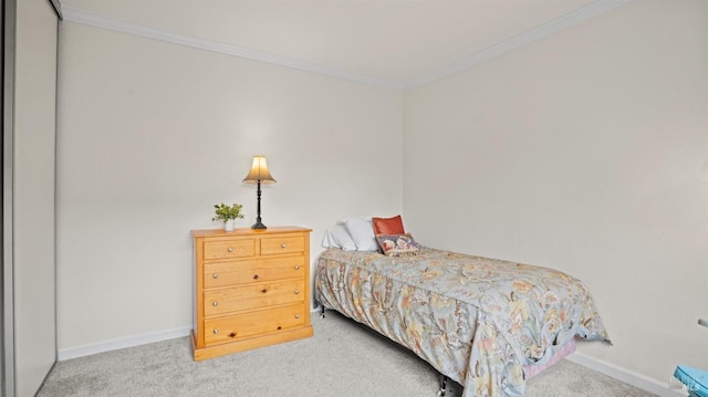 carpeted bedroom featuring baseboards and crown molding