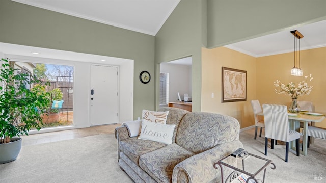 living area featuring light colored carpet, crown molding, a towering ceiling, and baseboards