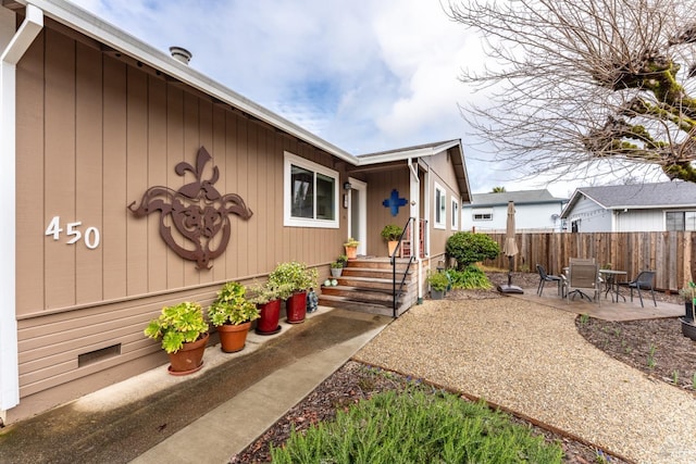 exterior space with crawl space, a patio area, and fence