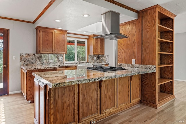 kitchen featuring light wood-type flooring, island exhaust hood, open shelves, and light stone countertops