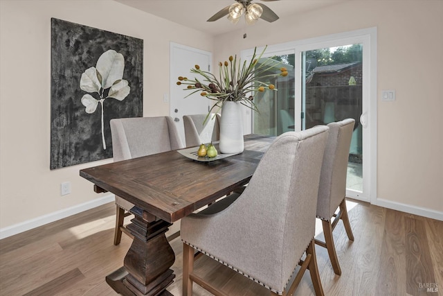 dining space featuring ceiling fan, wood finished floors, and baseboards