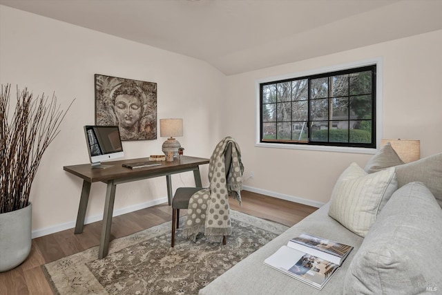 office area with vaulted ceiling, baseboards, and wood finished floors