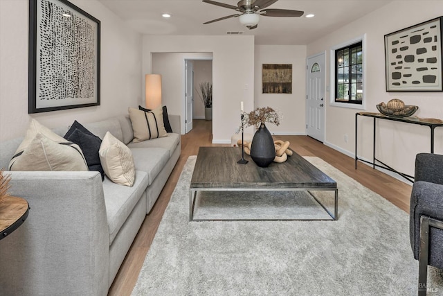 living area featuring recessed lighting, visible vents, light wood-style flooring, and baseboards