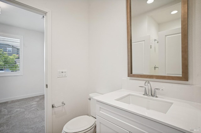 bathroom featuring recessed lighting, baseboards, vanity, and toilet