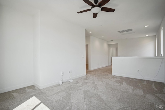 unfurnished room featuring light carpet, recessed lighting, visible vents, and baseboards