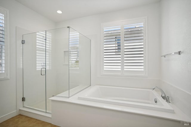 full bathroom with a shower stall, a bath, and recessed lighting