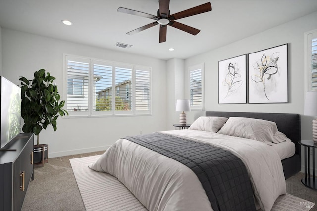 carpeted bedroom featuring baseboards, visible vents, a ceiling fan, and recessed lighting