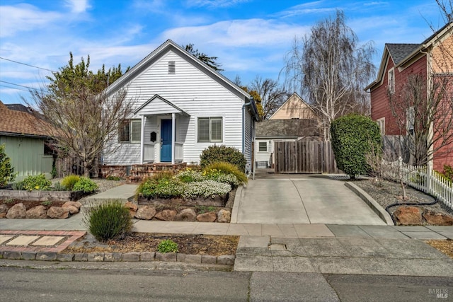 bungalow-style house with fence