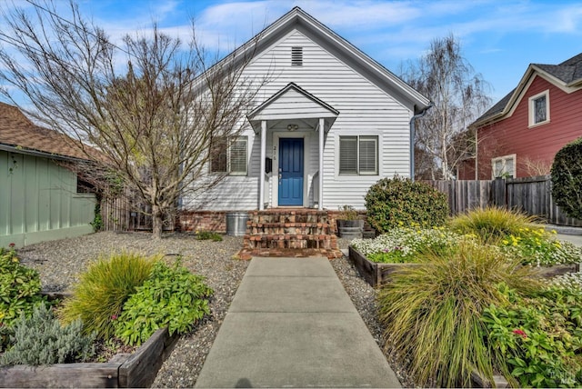 view of front of property with a garden and fence