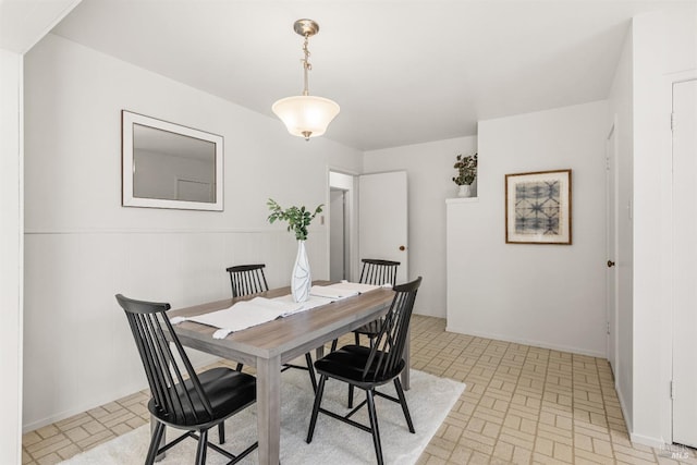 dining room featuring brick patterned floor