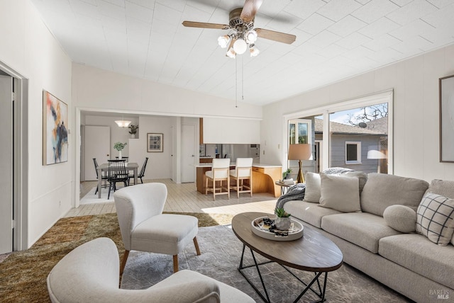 living room featuring lofted ceiling and a ceiling fan