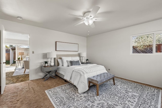 bedroom featuring a ceiling fan, carpet, and baseboards