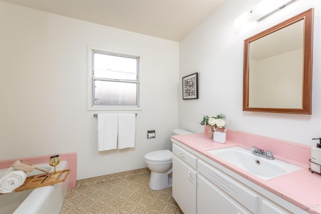 bathroom with a bath, vanity, and toilet