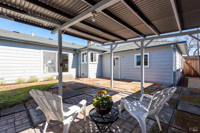 view of patio / terrace featuring entry steps and fence