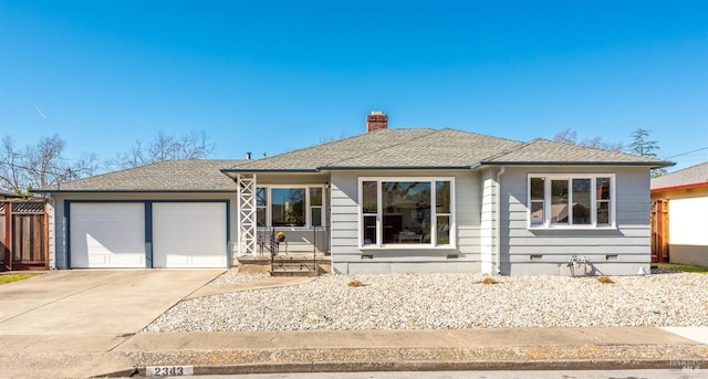 view of front facade with an attached garage, a shingled roof, driveway, crawl space, and a chimney