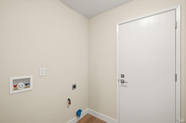 clothes washing area with hookup for an electric dryer, laundry area, washer hookup, baseboards, and light wood-type flooring