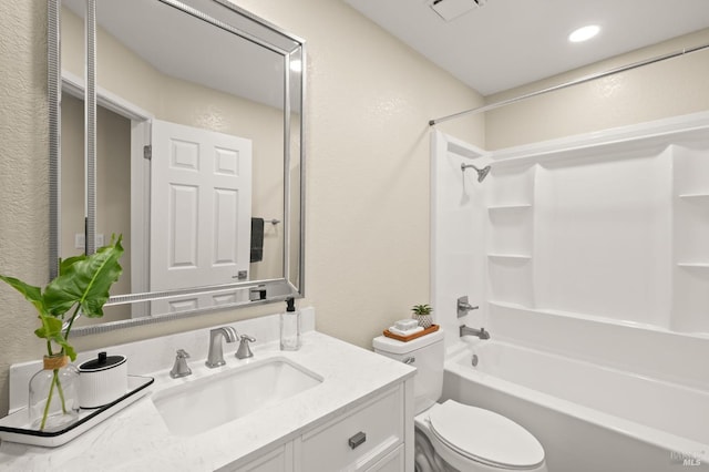 bathroom featuring visible vents, a textured wall, toilet, washtub / shower combination, and vanity