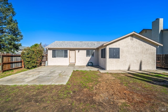 rear view of property with a patio area, a fenced backyard, and stucco siding