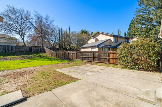 view of yard featuring a patio area and a fenced backyard