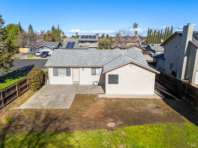 rear view of property with a patio area, a fenced backyard, and a residential view